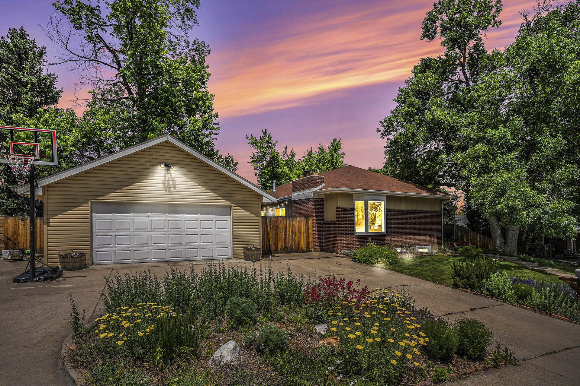 Exterior photo of a home at twilight with a two-car detached garage, showcasing a warm and inviting ambiance.