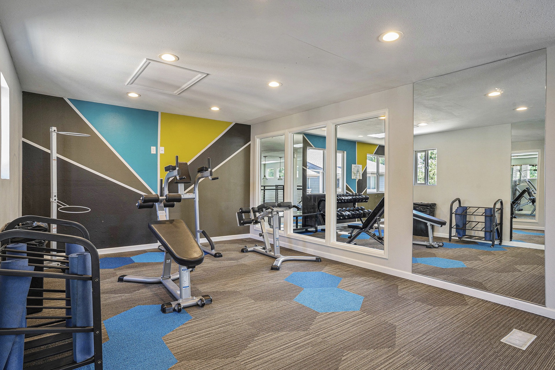 Modern gym facility at an apartment complex with state-of-the-art equipment and spacious layout.