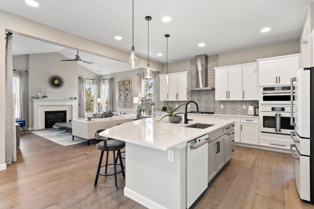 Gourmet chef's kitchen overlooking the living room with fireplace.