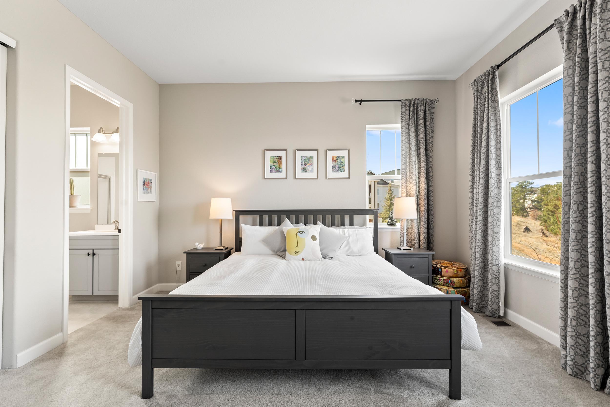 Bedroom with a private bathroom and views out of the windows.