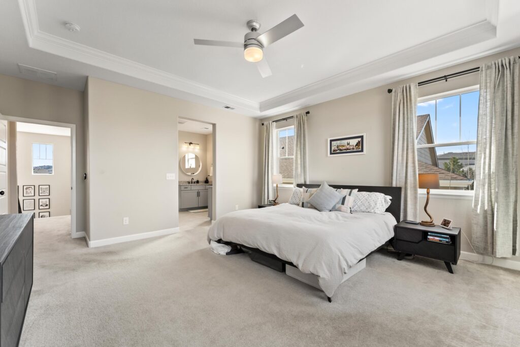 Spacious primary bedroom with views of the primary bathroom